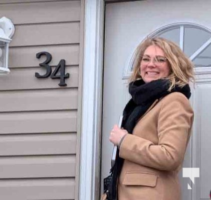 Anna opening the door to her new home