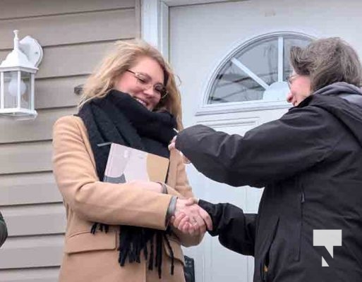Director of Construction Deb Wilson handing the keys over to Habitat Homeowner Anna